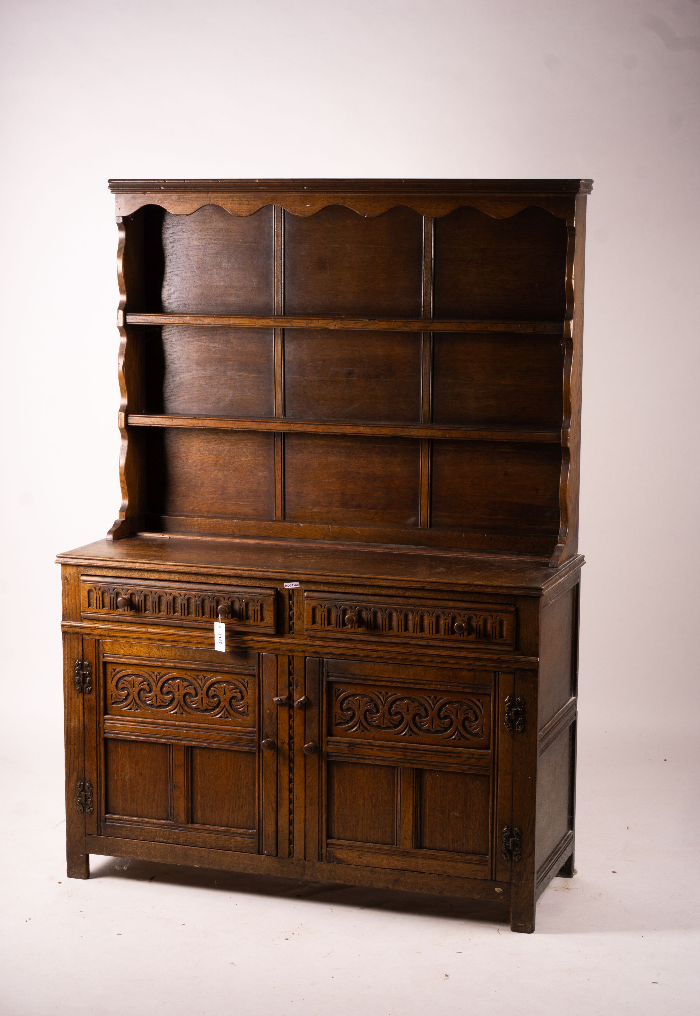 An 18th century style carved oak dresser, width 124cm, depth 46cm, height 175cm